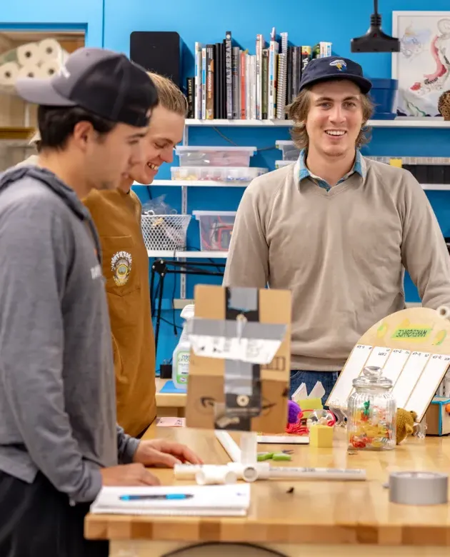 Three students work on a business project in the Makerspace